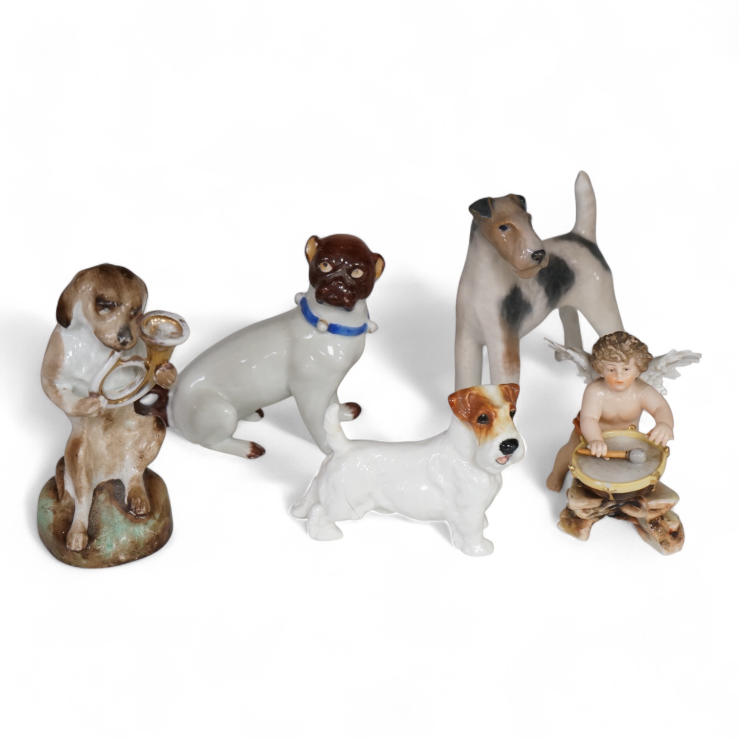 Four ceramic dogs by Copenhagen, Royal Doulton and two German examples, and a Volkstedt cherub drummer, tallest 12cm